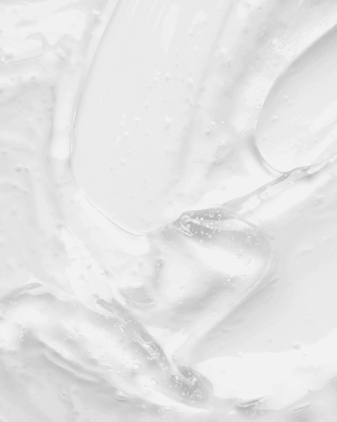 Weisses Gel fliesst über hellen Untergrund, abstrakte Darstellung flüssiger Substanz